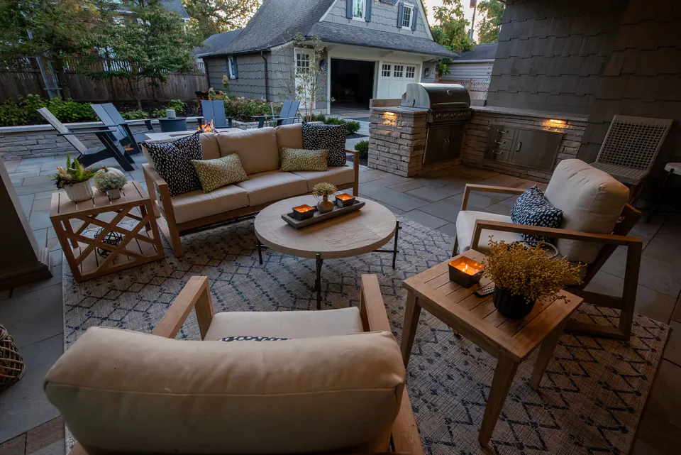 Square fire feature with open seating area on a paver terrace